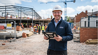Professional engineer on construction site holding tablet